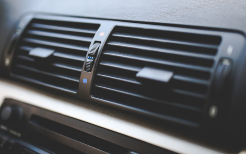 The air conditioning vents on the dash of a car