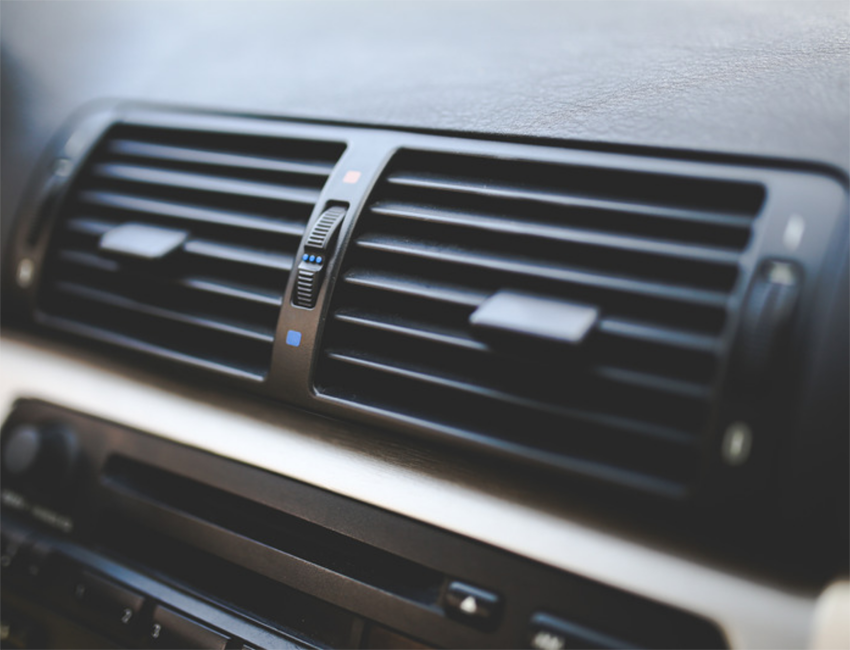 The air conditioning vents on the dash of a car